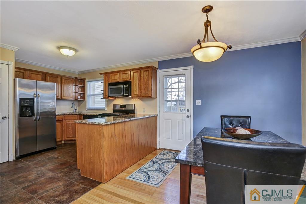 5 Baldwin Road Edison, NJ 08817 - Photo 6 of 25 a kitchen with stainless steel appliances a refrigerator and a stove top oven