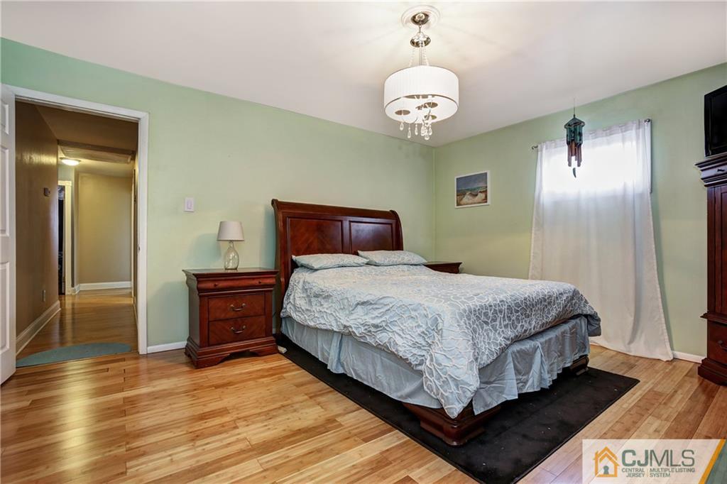 5 Baldwin Road Edison, NJ 08817 - Photo 8 of 25 a bedroom with a bed and wooden floor