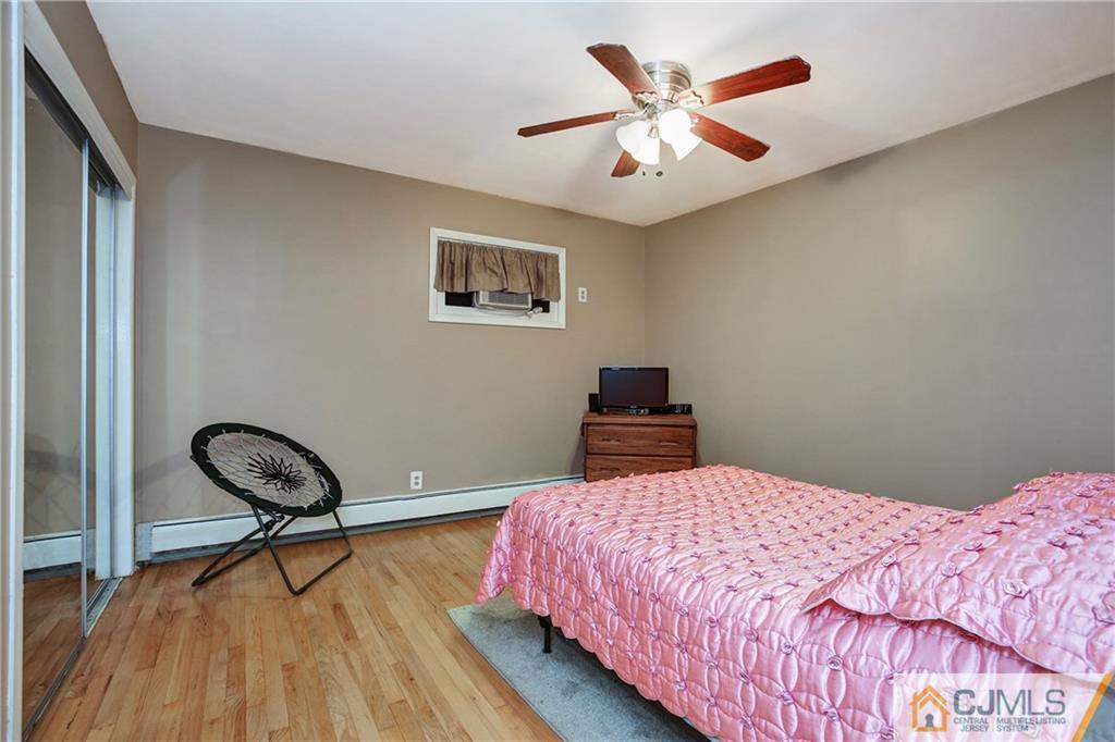 5 Baldwin Road Edison, NJ 08817 - Photo 9 of 25 a bedroom with a bed and a chandelier
