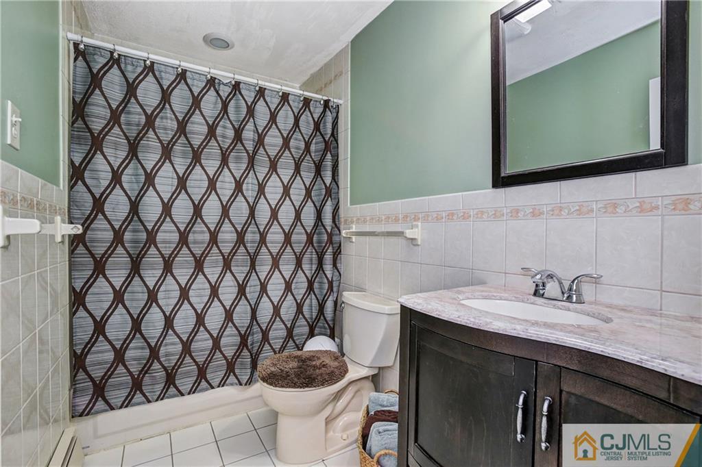5 Baldwin Road Edison, NJ 08817 - Photo 10 of 25 a bathroom with a sink and a mirror