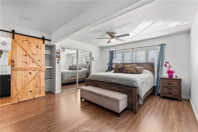 a bedroom with a bed and a large window