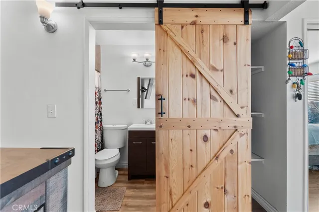 a bathroom with a granite countertop sink a toilet and a mirror
