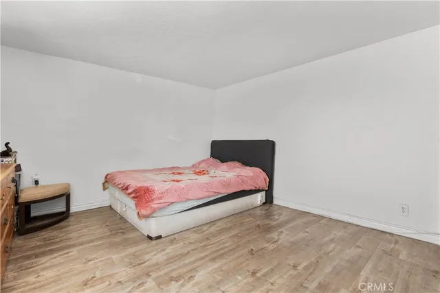 a bedroom with a bed and a chair