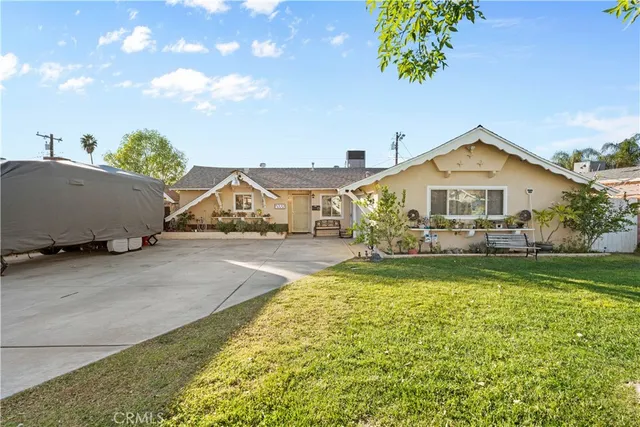 a front view of a house with a garden and yard