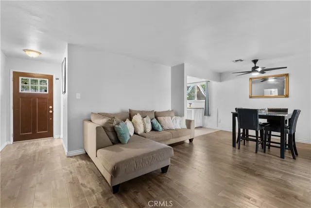 a living room with furniture and wooden floor