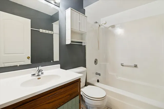 a bathroom with a sink toilet tub and shower