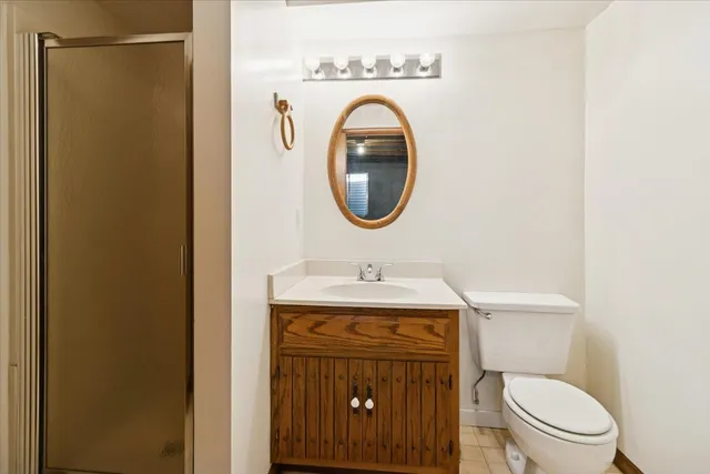 a bathroom with a toilet a sink and a mirror