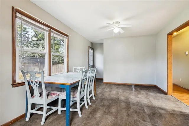 a view of a dining room with furniture and a chandelier