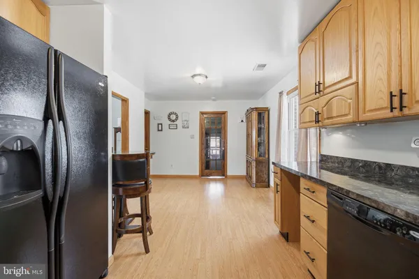 a kitchen with stainless steel appliances granite countertop a refrigerator and a stove top oven