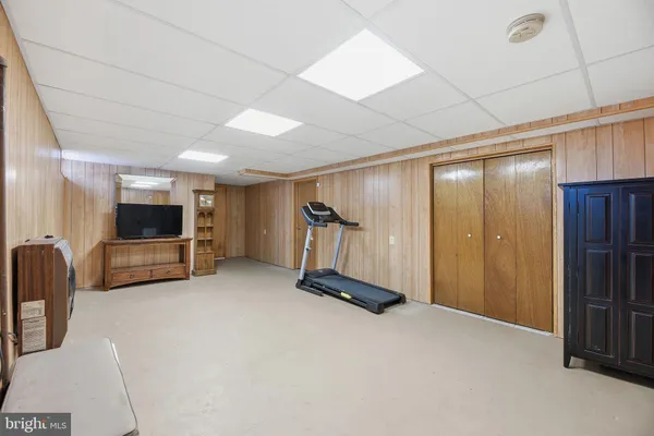 a view of a room with gym equipment and a window