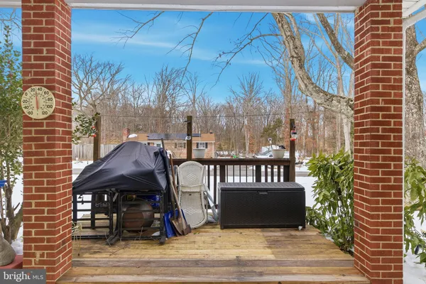 a view of a large white house with a yard covered in snow