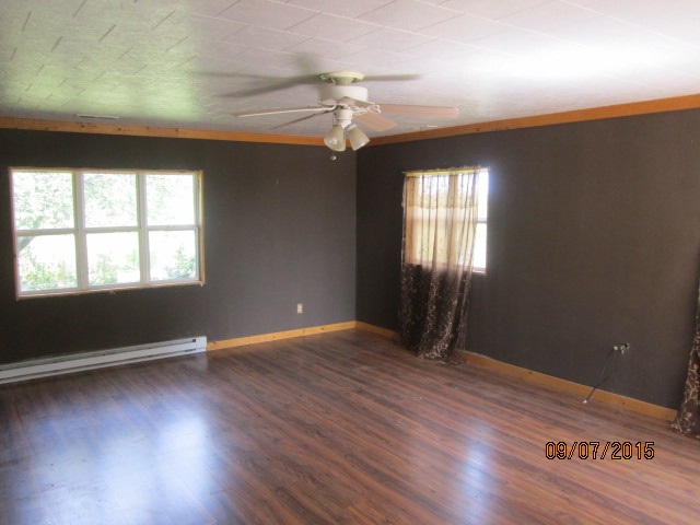 4404 East Walden Road Byron, IL 61010 - Photo 5 of 7 an empty room with wooden floor and windows