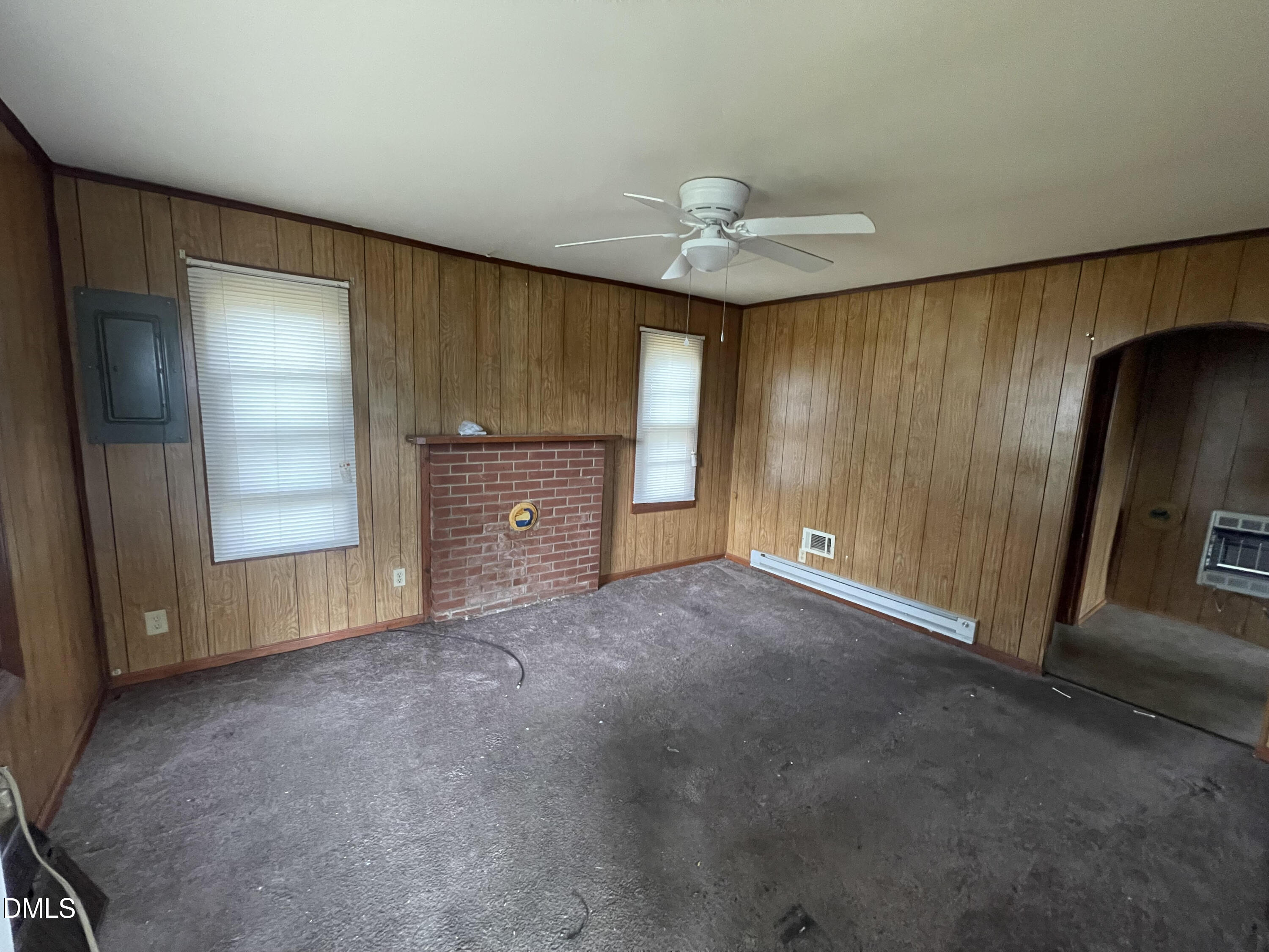 1023 Leasburg Road Roxboro, NC 27573 - Photo 5 of 12 wooden floor in an empty room with a fireplace