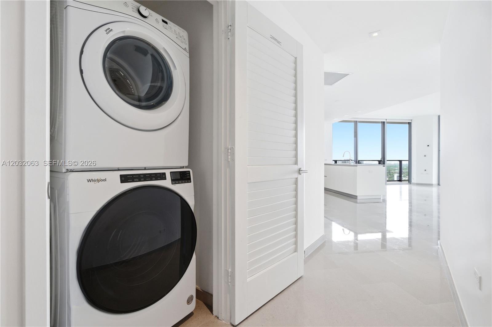 88 Southwest 7th Street, Unit 2302 Miami, FL 33130 - Photo 19 of 26 a view of a hallway with washer and dryer