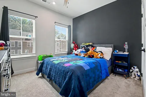 a bed sitting in a bedroom next to a window