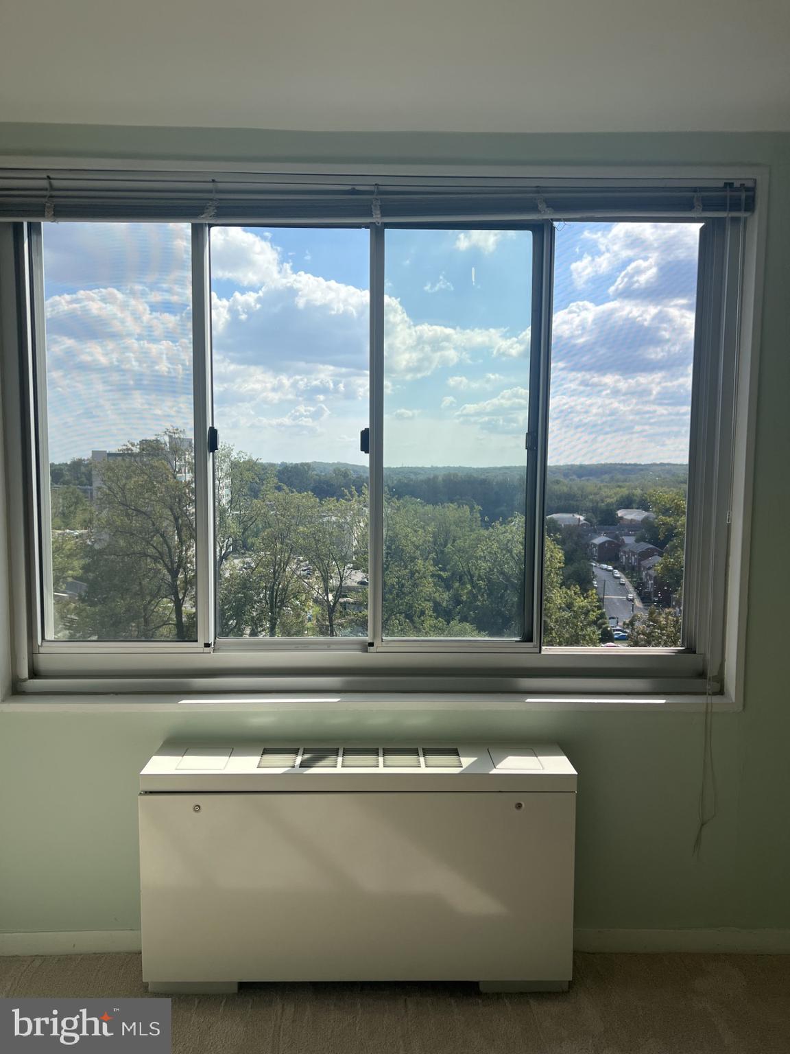 1900 Lyttonsville Road, Unit 1308 Silver Spring, MD 20910 - Photo 28 of 52 a living room with a large window and a table