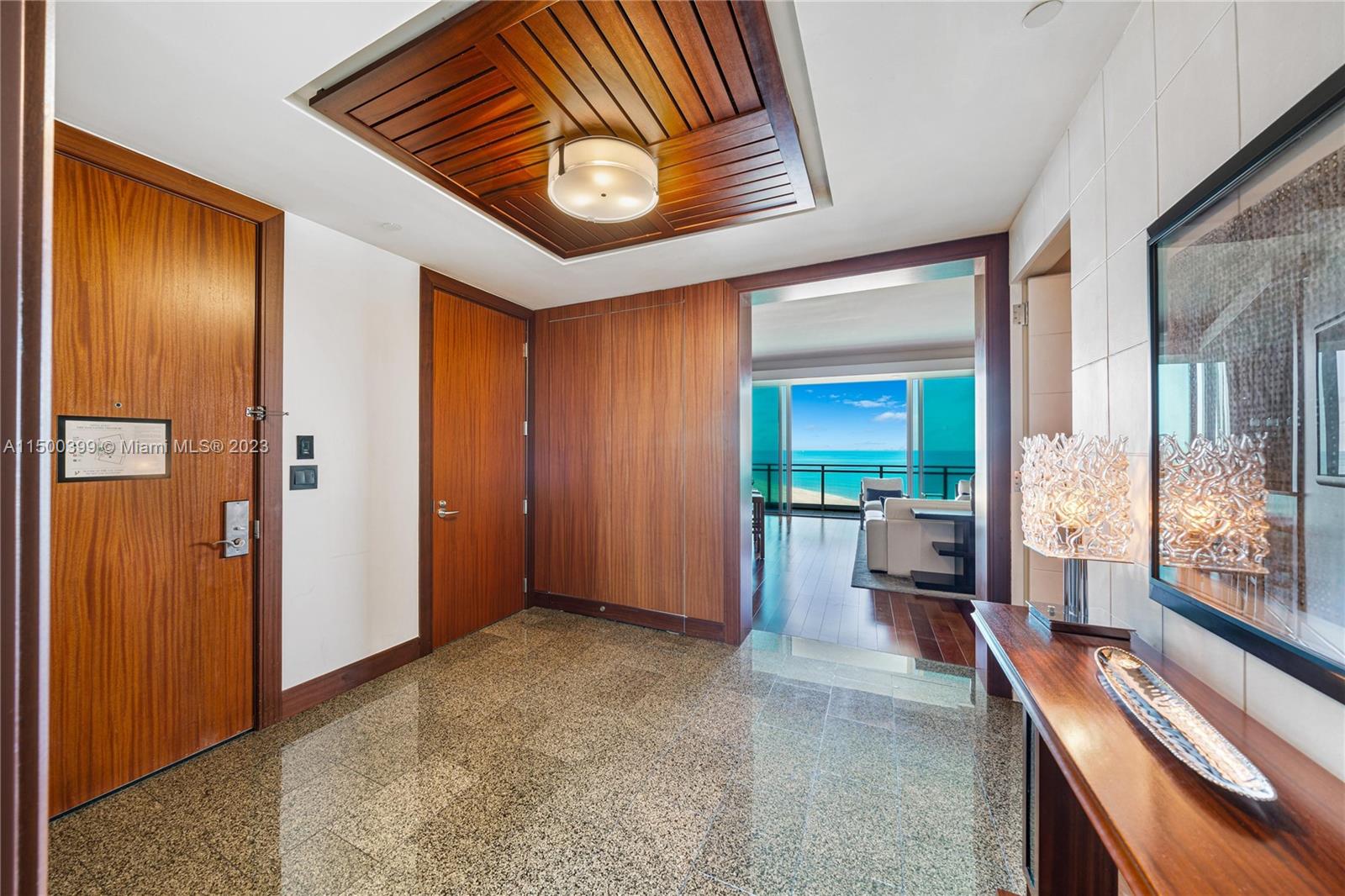 10295 Collins Avenue, Unit 1217 Bal Harbour, FL 33154 - Photo 18 of 26 a view of a hallway with furniture and front door