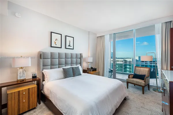 a bedroom with a bed and a television