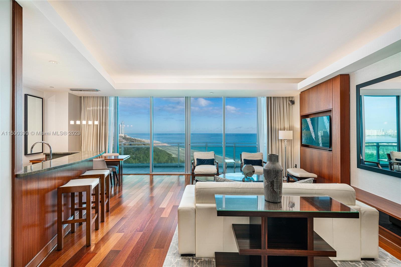 10295 Collins Avenue, Unit 1217 Bal Harbour, FL 33154 - Photo 2 of 26 a living room with furniture a large window and wooden floor