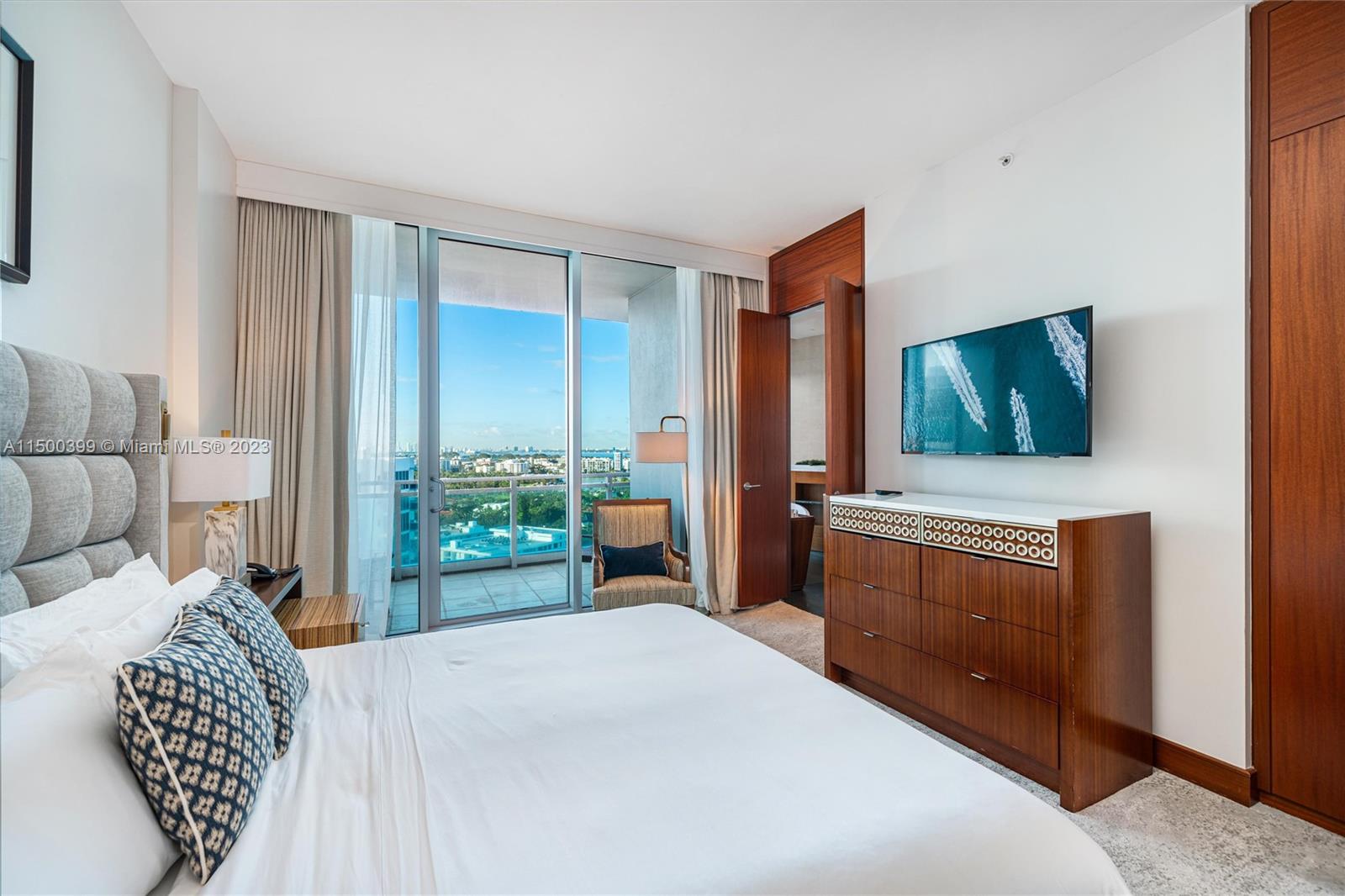 10295 Collins Avenue, Unit 1217 Bal Harbour, FL 33154 - Photo 21 of 26 a bedroom with a bed and a television