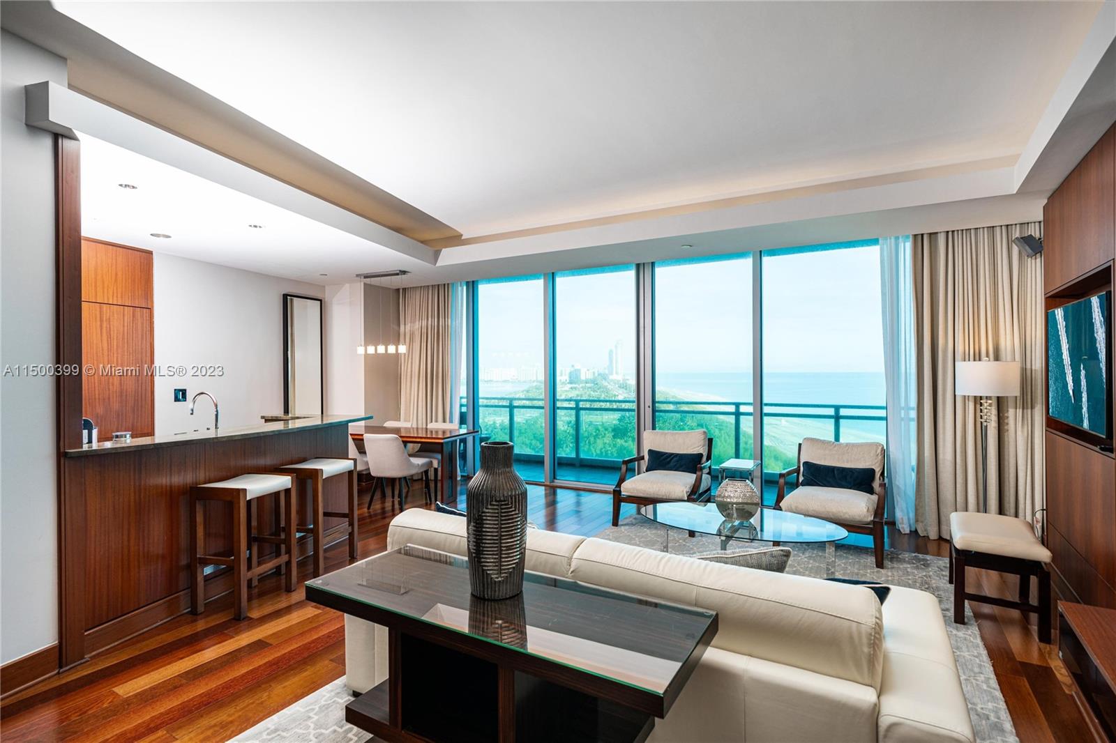 10295 Collins Avenue, Unit 1217 Bal Harbour, FL 33154 - Photo 3 of 26 a living room with furniture and large windows