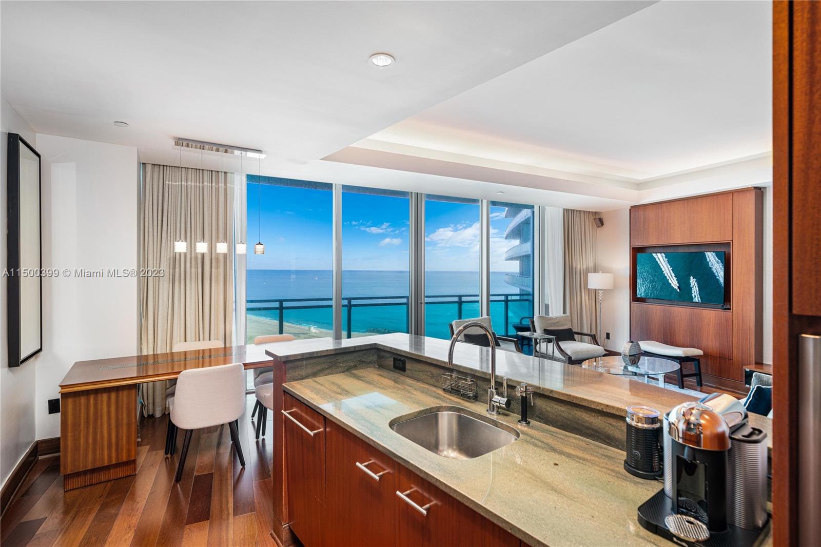 10295 Collins Avenue, Unit 1217 Bal Harbour, FL 33154 - Photo 9 of 26 a kitchen with a sink and a large window