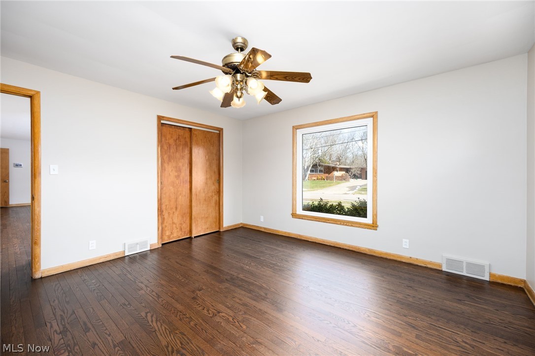 364 Mowbray Road Akron, OH 44333 - Photo 28 of 44 Unfurnished bedroom featuring dark wood-style floors, a closet, and a ceiling fan