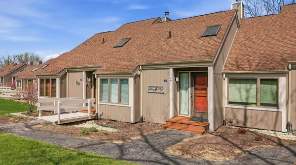 a view of a house with backyard porch and sitting area