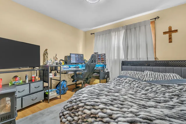 a bedroom with furniture and a flat screen tv