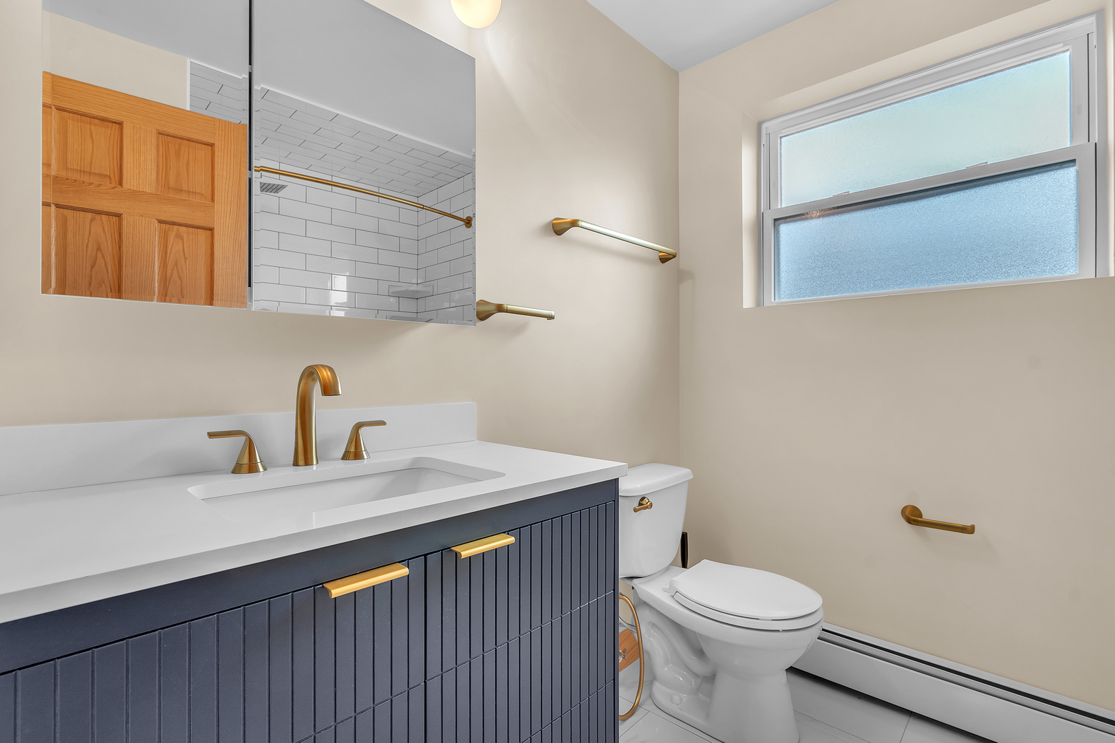 6048 West 79th Street Burbank, IL 60459 - Photo 18 of 34 a bathroom with a sink a toilet and mirror