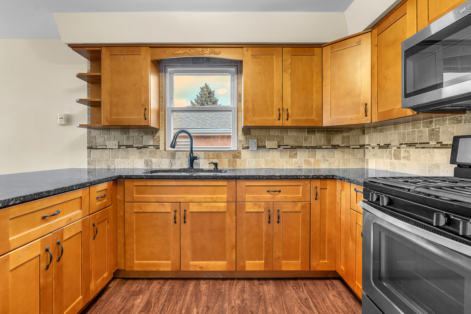 6048 West 79th Street Burbank, IL 60459 - Photo 23 of 34 a kitchen with stainless steel appliances granite countertop a sink stove and cabinets