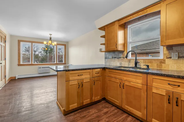 a kitchen with wooden cabinets and a sink