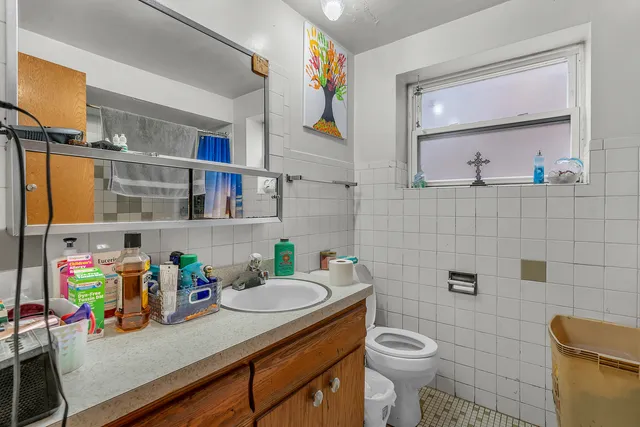 a bathroom with a sink a toilet and a mirror