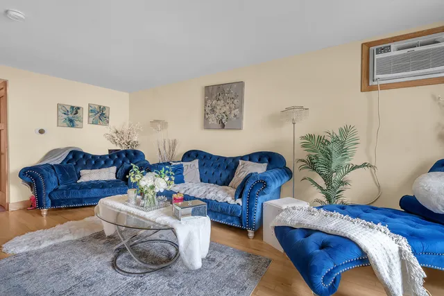 a living room with furniture and a potted plant