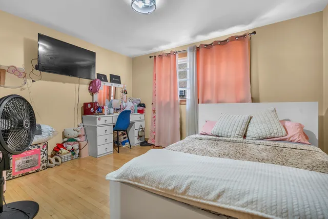 a bedroom with a bed and a flat tv screen