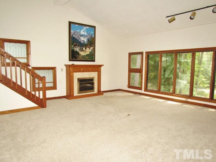 224 Bayleaf Drive Raleigh, NC 27615 - Photo 8 of 22 a view of an empty room with a window and a fireplace