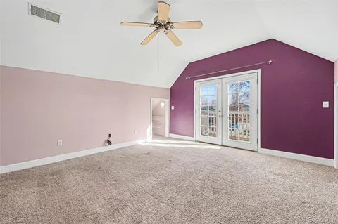 an empty room with wall painting and windows