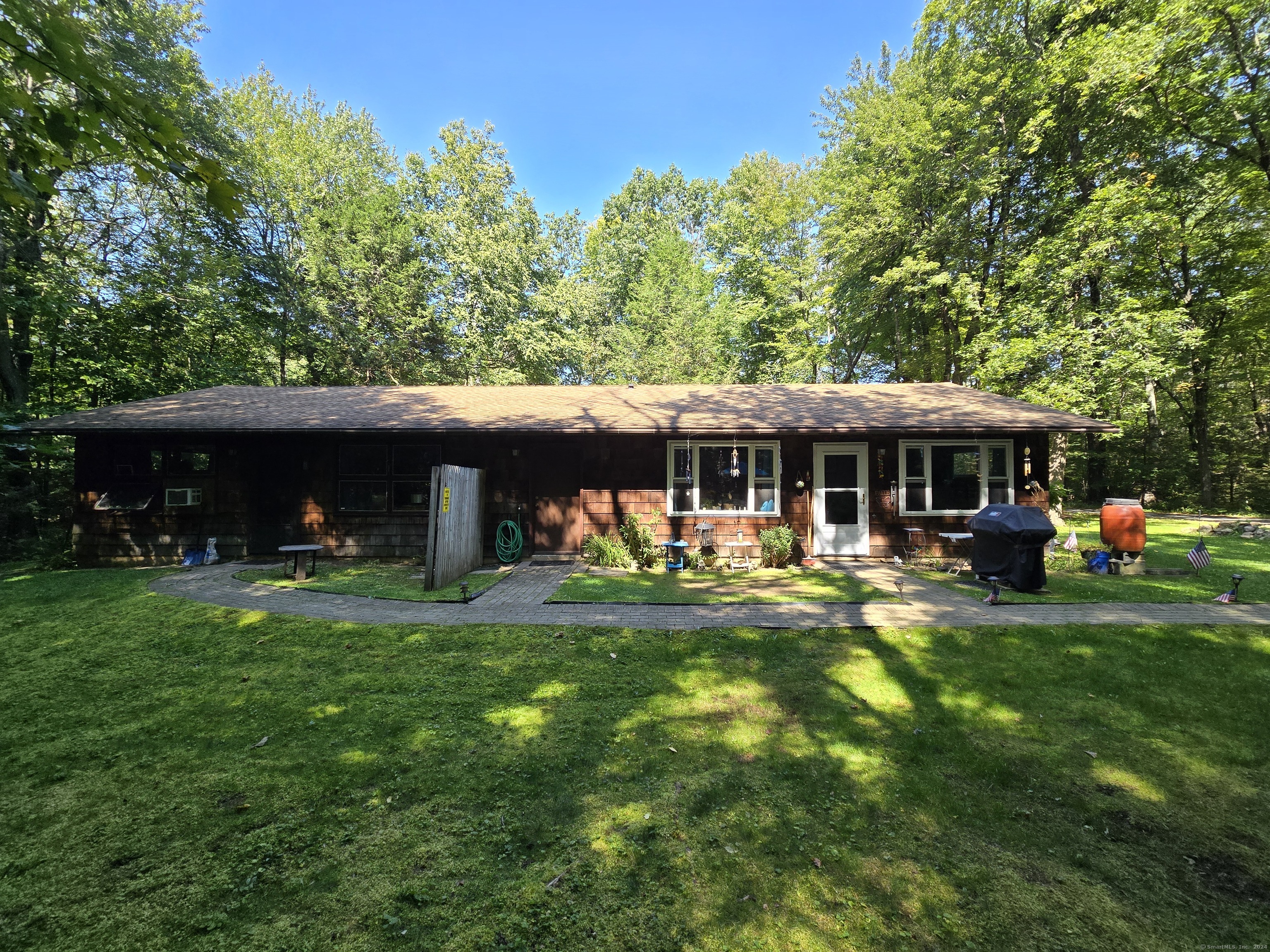 a view of a house with a yard porch and sitting area
