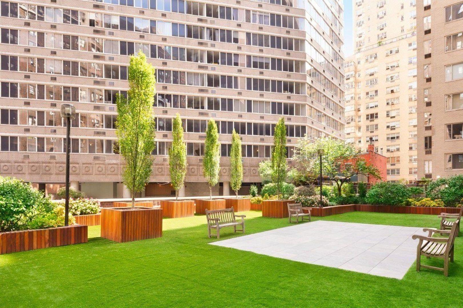 400 East 54th Street, Unit 14E Manhattan, NY 10022 - Photo 12 of 14 a view of a building with a big yard