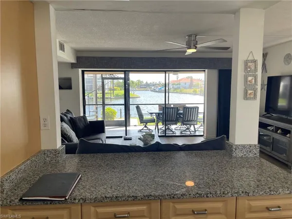 a view of kitchen with granite countertop cabinets and outdoor view