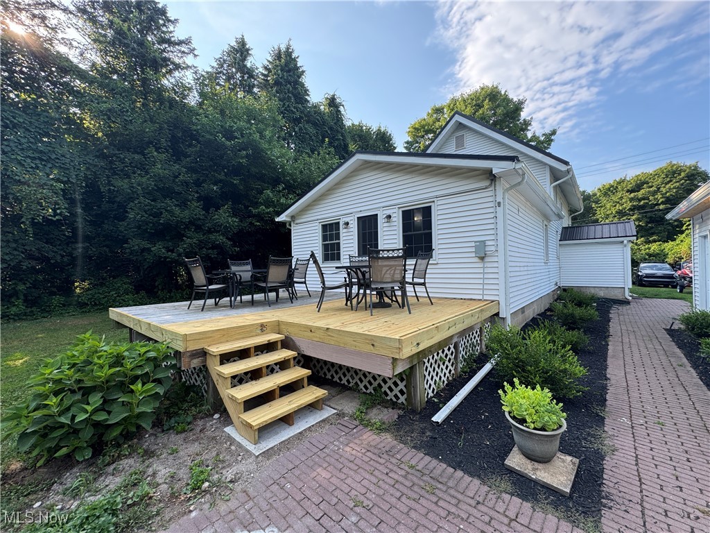 5322 Lockwood Road Madison, OH 44057 - Photo 28 of 30 Wooden deck featuring outdoor dining area and brick walks