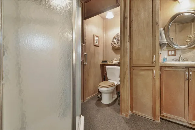 a bedroom with a bed dresser and a flat tv screen