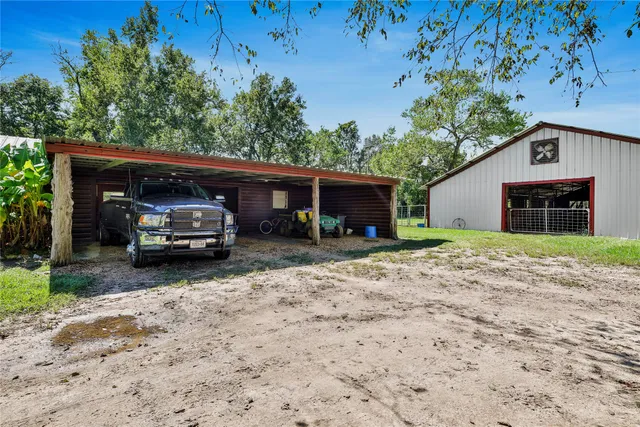 a backyard of a house with yard barbeque oven and outdoor seating