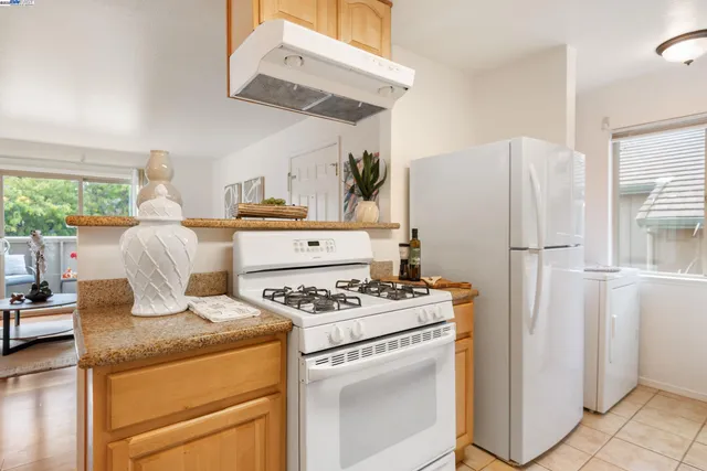a kitchen with stainless steel appliances a stove a sink and cabinets