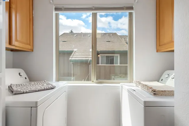 a view of a chair and table in backyard of the house