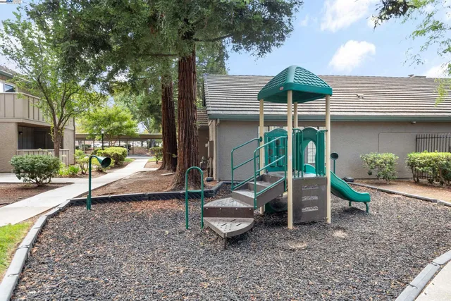 a view of a house with a backyard and a slide