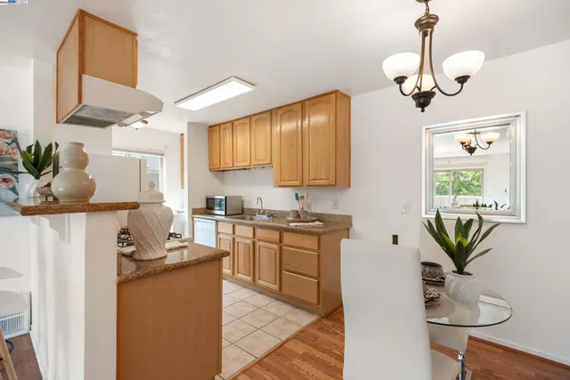 a kitchen with stainless steel appliances a sink a stove and cabinets