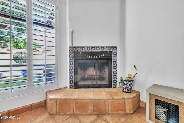 a living room with a fireplace furniture and a potted plant