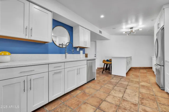 a kitchen with a sink and cabinets