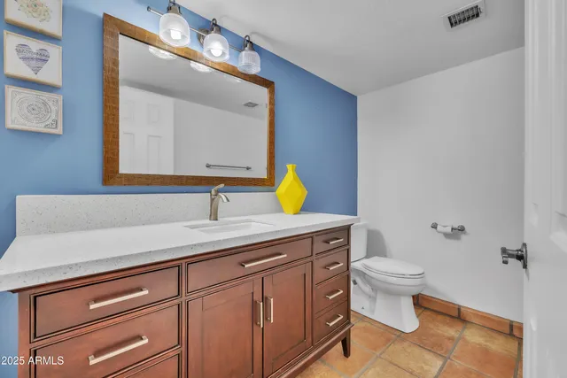 a bathroom with a sink a toilet and mirror